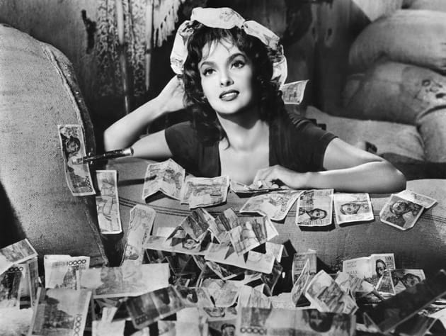 Gina Lollobrigida posait face &agrave; une pile de billets dans le film "La Loi"
