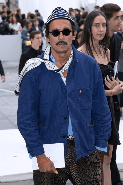 Haider Ackermann en veste bleu de travail et pantalon imprimé