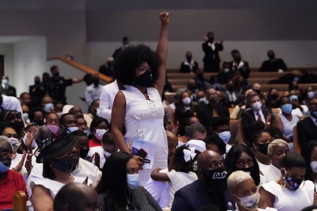 Les participants se lèvent pour participer aux chants pendant la cérémonie