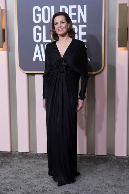 Sigourney Weaver en robe noire avec une fleur Saint Laurent