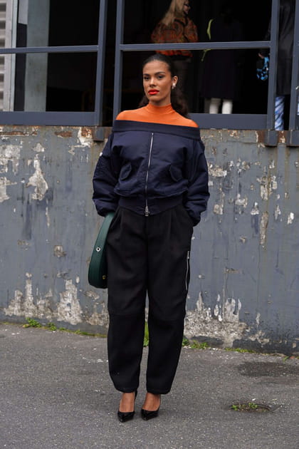 Tina Kunakey en bomber à encolure Bardot et baggy noir Coperni