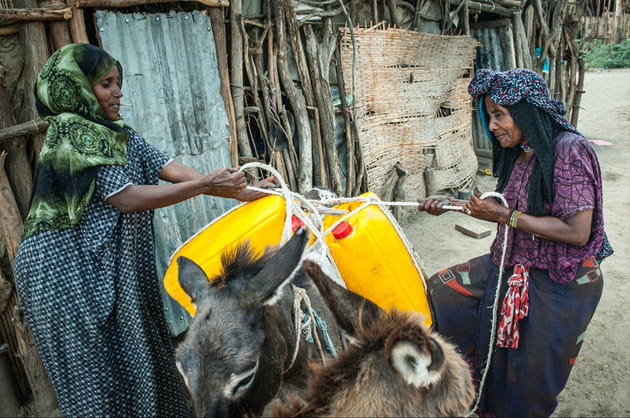 Une femme âgée part la recherche de l'eau