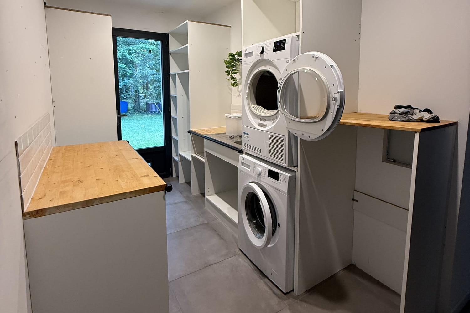 a narrow space reinvented into a laundry room full of storage