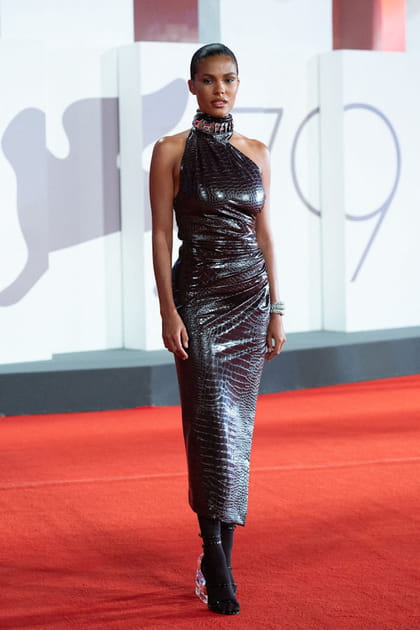 Tina Kunakey en robe asymétrique imprimé crocodile Alaïa