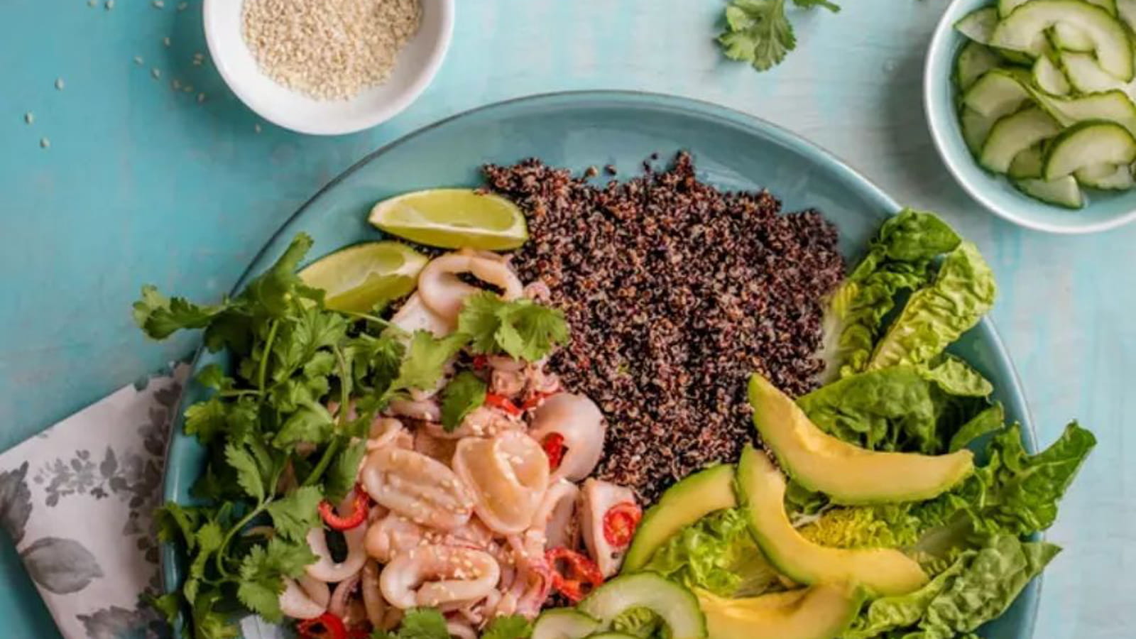 Salade de calamar à l’ail et au chili accompagnée de concombre, avocat et quinoa
