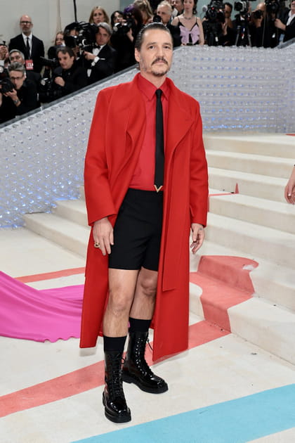 Pedro Pascal en manteau rouge et short noir Valentino